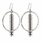 A pair of silver-toned dangle earrings featuring a hammered oval hoop with a textured vertical chevron or feather-like drop hanging from the center, suspended from fishhook wires, shown against a plain white background.