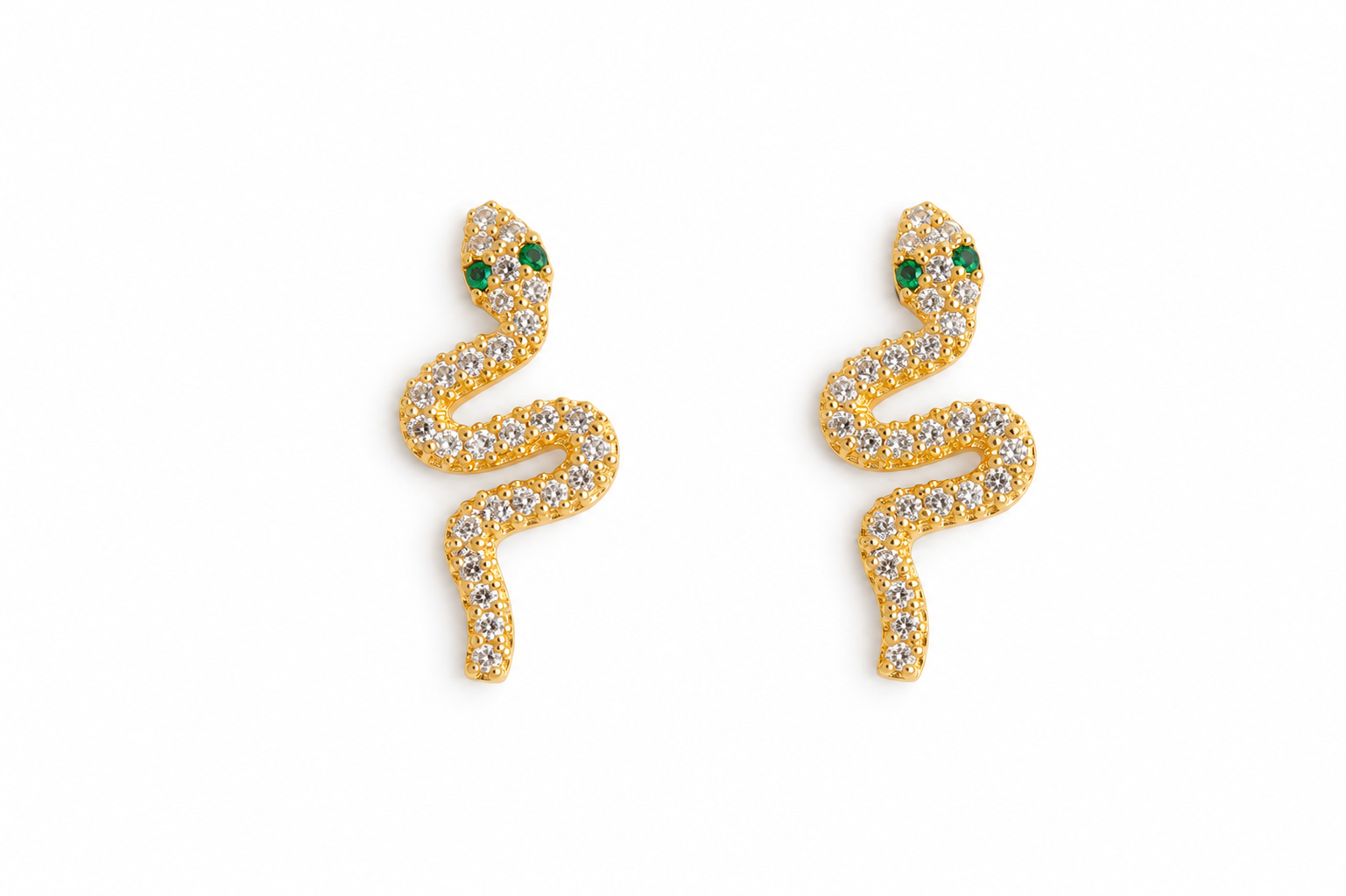 Gold snake-shaped earring with green gemstones on a white background