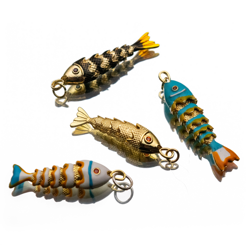 Four colorful fish-shaped jewelry pendants on a white background