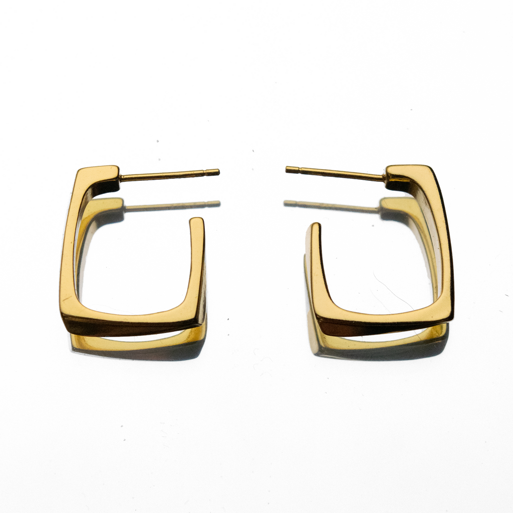 Gold hoop earrings on a white background