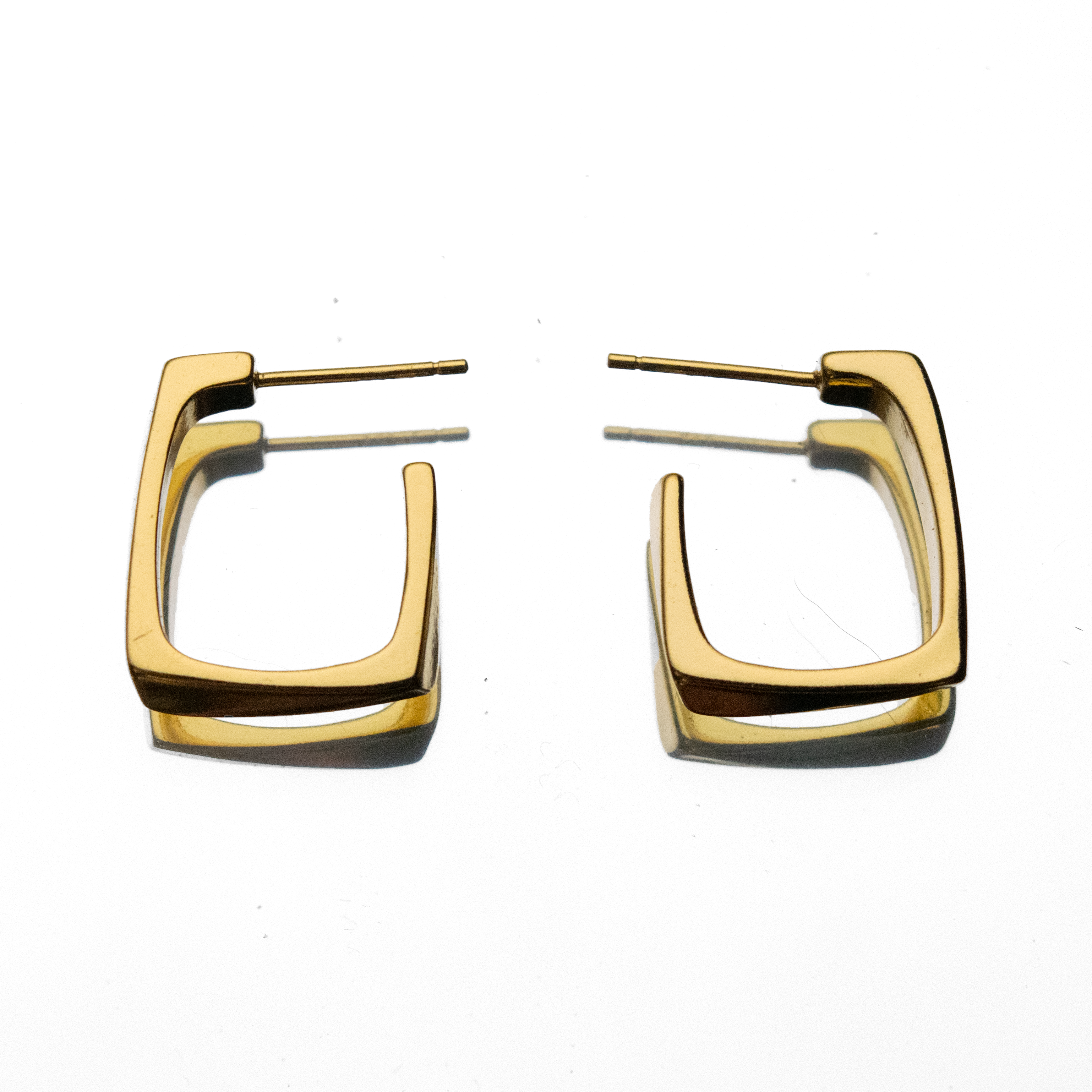 Gold hoop earrings on a white background